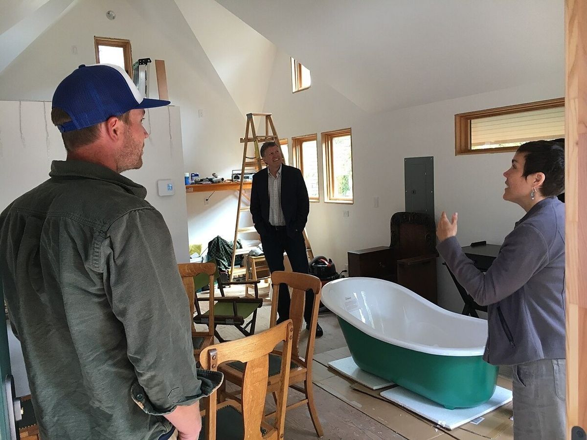 Visitors inside a finished backyard cottage