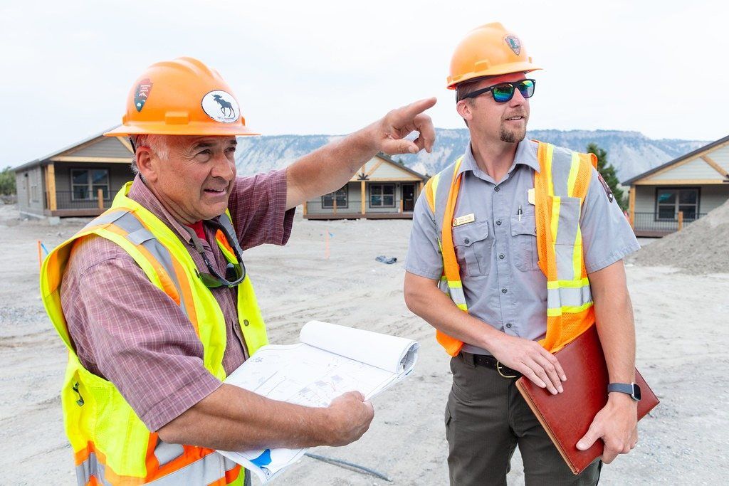 Engineer and building inspector reviewing plans on site