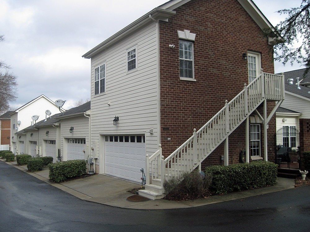 Two-story ADU with exterior stairs facing an alley